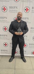 Dwight Barrett Communications ENO at the BHPN Awards dinner with his Emerging Leader Award